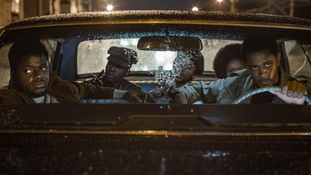Daniel Kaluuya and Lakeith Stanfield riding in a car with other Black Panthers as seen in Judas and the Black Messiah. 