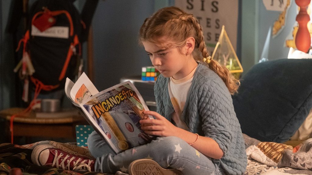 Matilda Lawler as Flora reading comics in FLORA & ULYSSES, exclusively on Disney+.