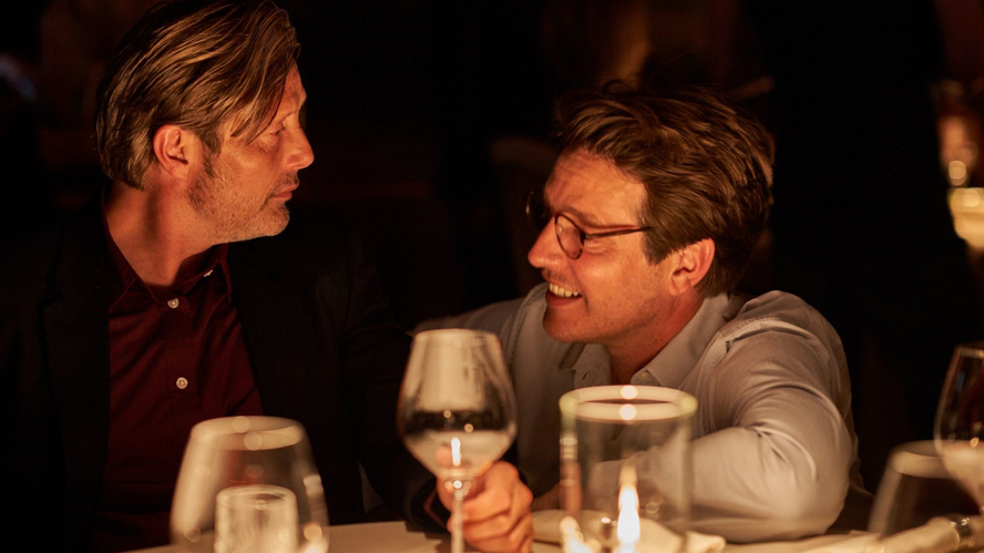 Thomas Vinterberg, the director of Another Round, alongside Mads Mikkelson