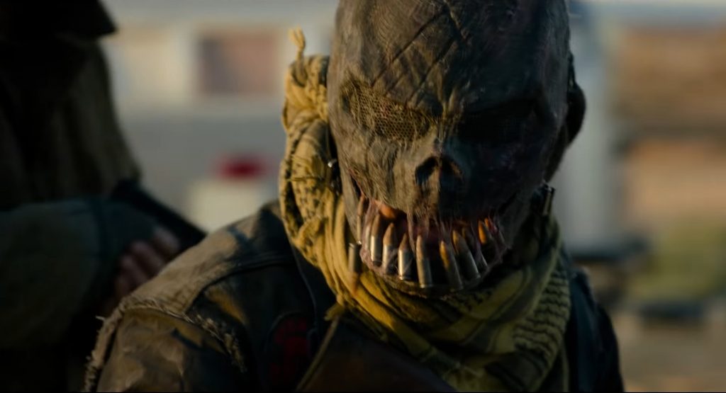 A purger with a scarecrow-like mask with bullets as teeth as seen in THE FOREVER PURGE produced by Blumhouse and JASON BLUM.