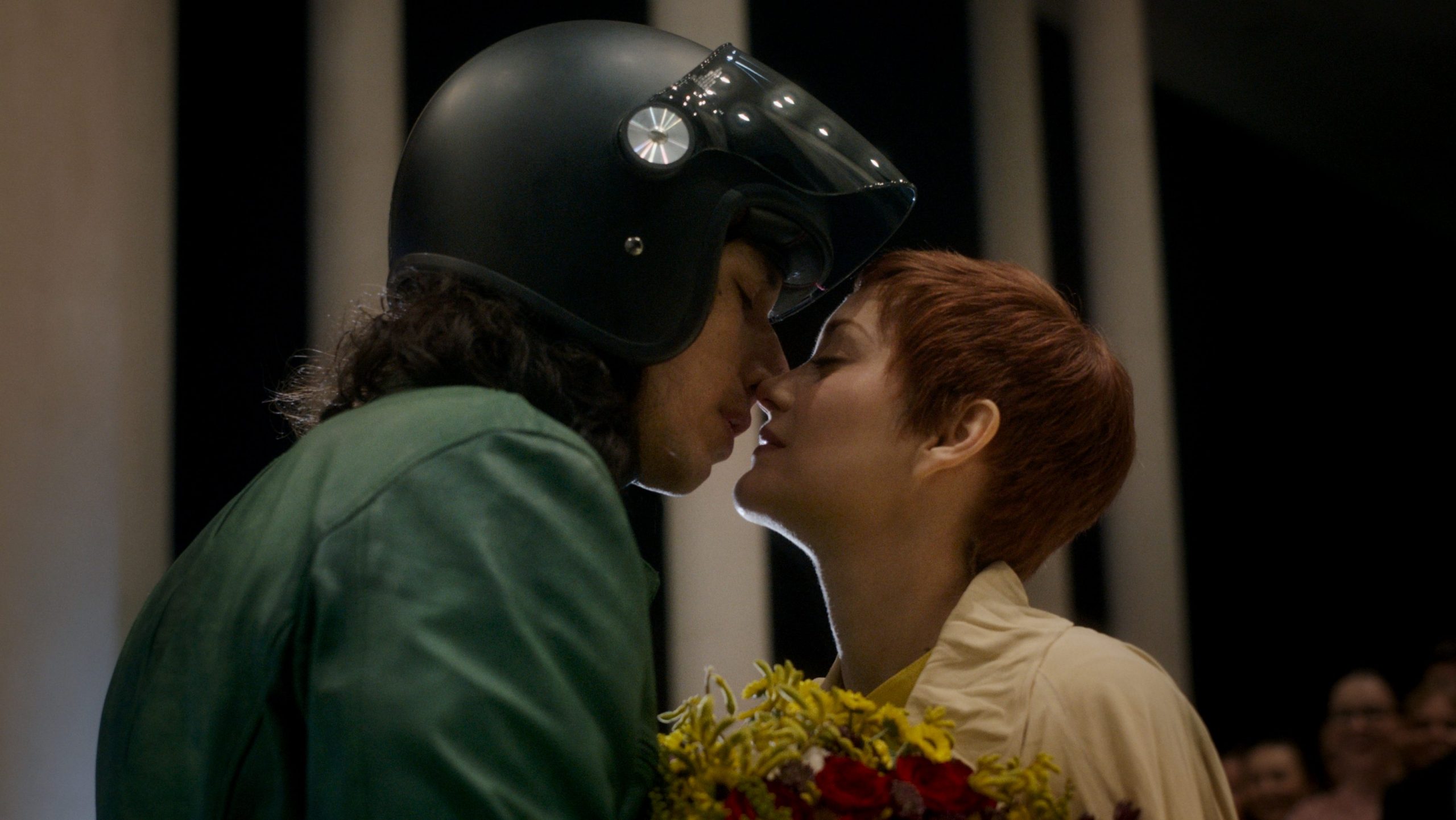 Adam Driver and Marion Colllitard share an intimate kiss as paparazzi flash photos outside of the Walt Disney Concert Hall as seen in the new musical ANNETTE.