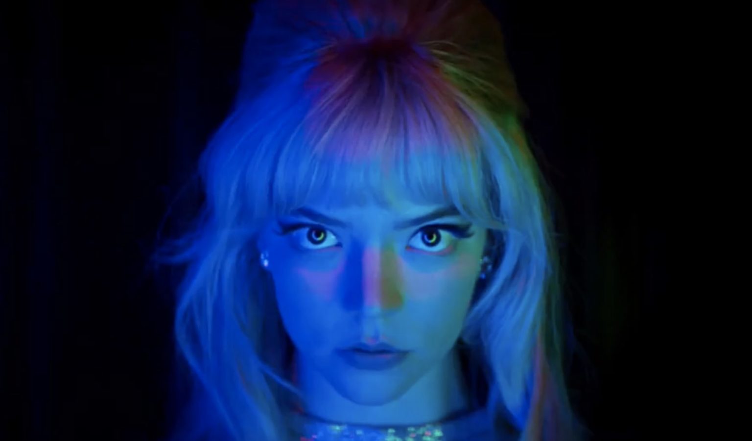Anya Taylor-Joy in neon blue and green lighting as seen in LAST NIGHT IN SOHO directed by Edgar Wright.