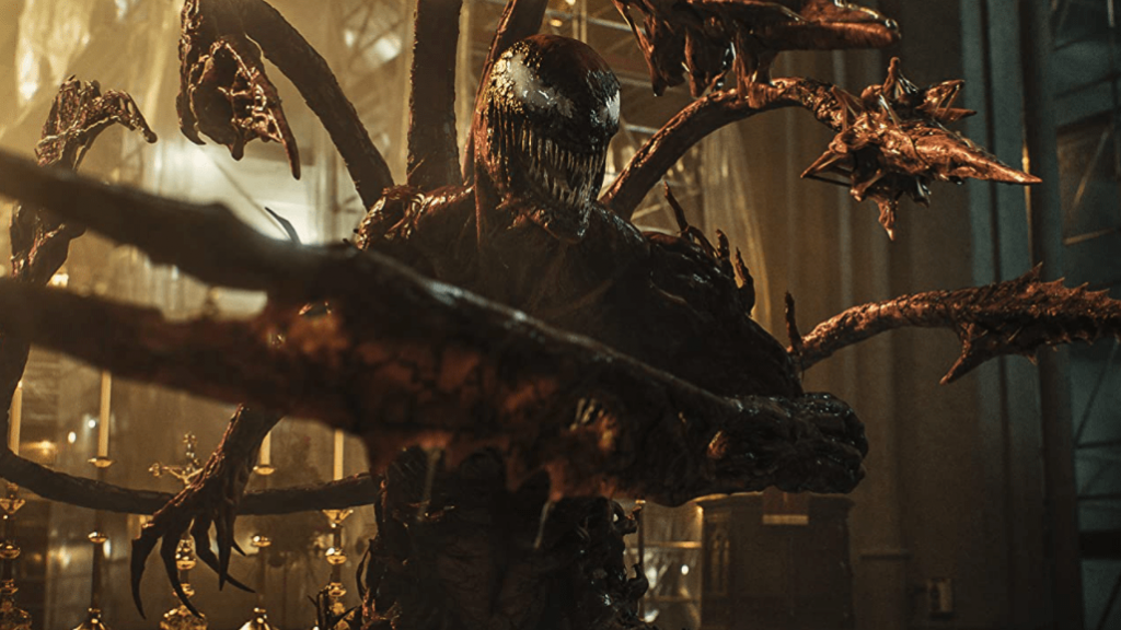 Carnage, ready for battle, sticks out all of his tentacles and claws as seen in VENOM: LET THERE BE CARNAGE starring Tom Hardy and Woody Harrelson