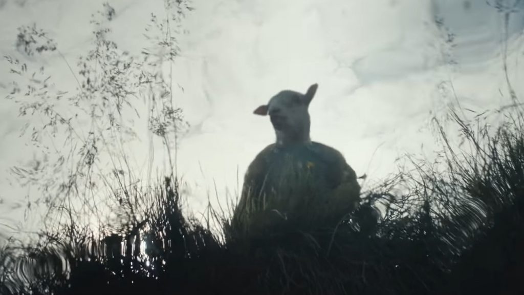 The half-human, half-lamb hybrid child Ada stares at her own reflection on a clear river as seen in the new A24 horror film LAMB.