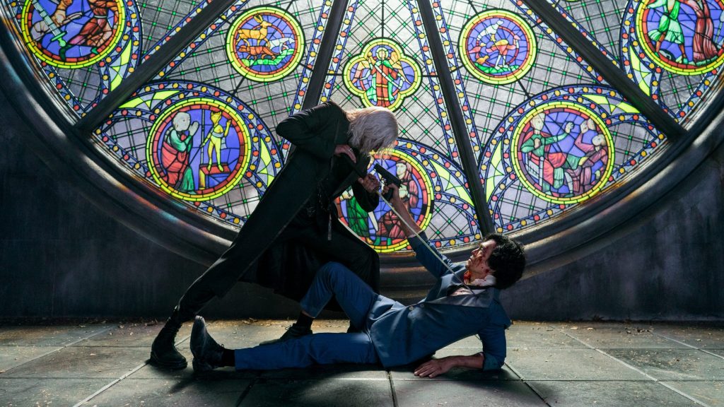 The iconic shot of Vicious and Spike Spiegel facing off with a sword and gun in front of a colorful Mosaic glass church window is recreated from the original anime in the Netflix live-action adaptation of COWBOY BEBOP.