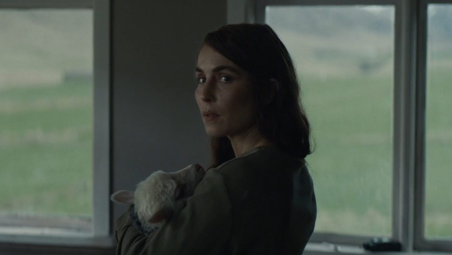 Noomi Rapace cradles her newborn half-human, half-sheep hybrid baby daughter Ada to sleep as seen in the latest A24 horror film LAMB.