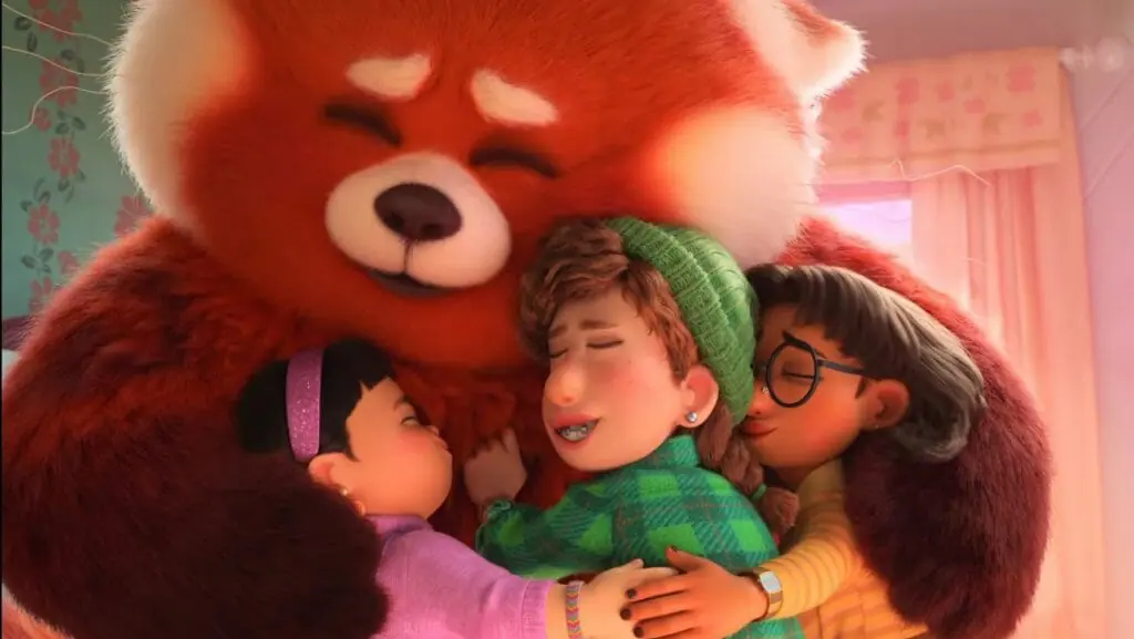 Mei in her giant Red Panda form shares a large heartwarming group hug with her 3 best friends Abby, Ava, and Maitreyi in the new Pixar film TURNING RED streaming on Disney+.