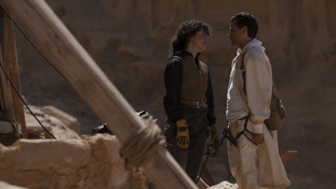 May Calamawy and Oscar Isaac share a moment together while strapped to climbing gear in the Cairo desert in the new MCU series on Disney+ MOON KNIGHT.