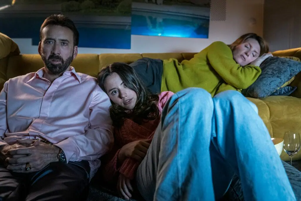 Lily Sheen rests her head on Nicolas Cage's shoulder as father and daughter watch Paddington 2 for the first time together in THE UNBEARABLE WEIGHT OF MASSIVE TALENT.