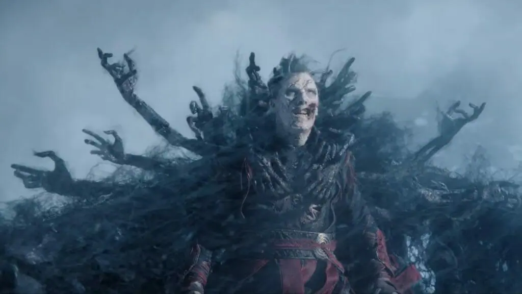 A zombie version of Doctor Strange prepares to take flight as dark black demon souls wrap their skeleton hands around him to form a ghostly cloak of levitation in DOCTOR STRANGE IN THE MULTIVERSE OF MADNESS directed by Sam Raimi and written by Michael Waldron.