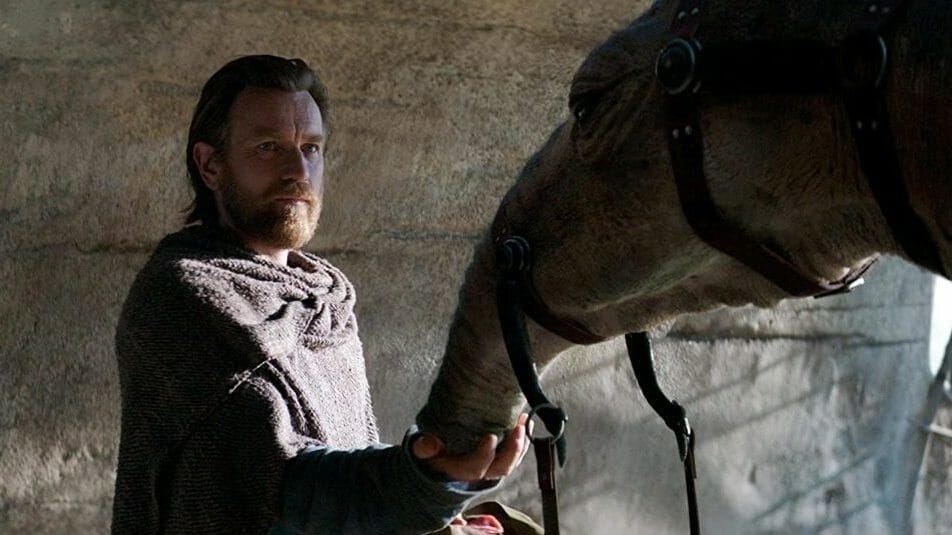 New Arrivals for Disney+ May 2022 Ewan McGregor as Obi-Wan Kenobi attends to a space camel called an Eopie in the new Star Wars series premiering in May 2022 on Disney+.
