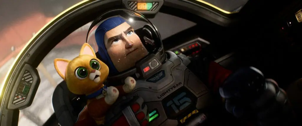 Buzz Lightyear prepares to attempt a hyper-speed test flight with his small orange robot cat companion Sox at his shoulders in Pixar's LIGHTYEAR.