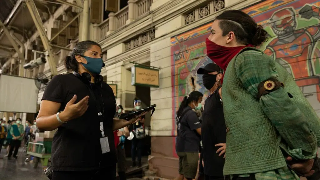 Sharmeen Obaid-Chinoy walks Aramis Knight in full costume as the Red Dagger on the Karachi, Pakistan set of the MCU Disney+ series MS. MARVEL.