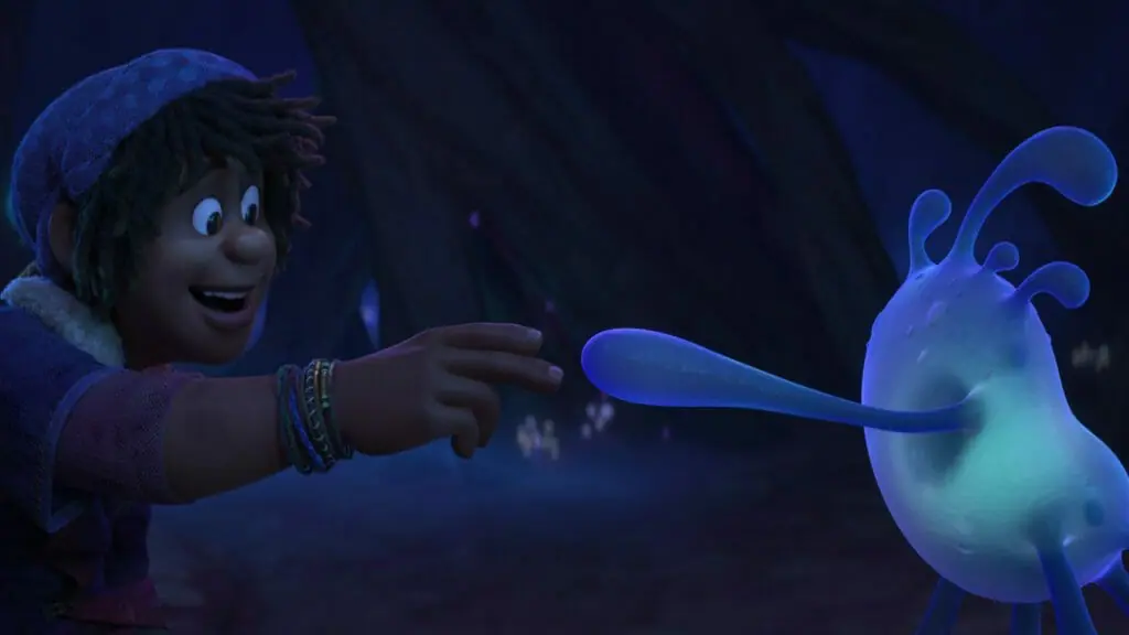 Ethan Clade voiced by Jaboukie Young-White meets and shakes the hand of Splat the new blue creature sidekick in STRANGE WORLD from Walt Disney Animation.