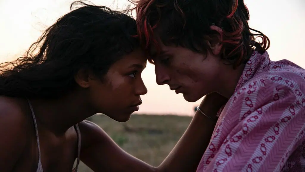 Timothée Chalamet and Taylor Russell lock their heads together in an intimate moment from the young cannibal love story BONES AND ALL.