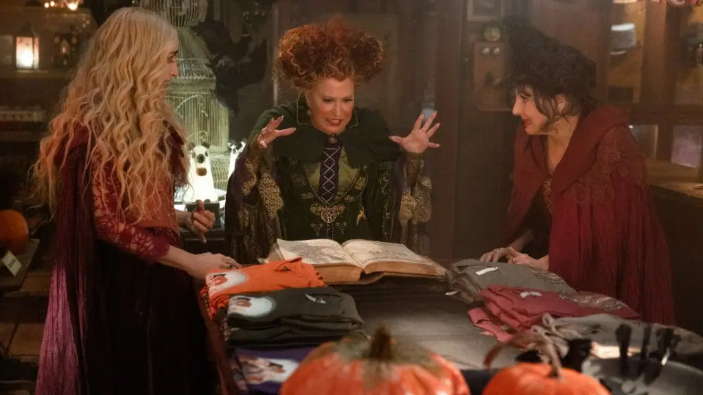 The iconic Sanderson witch sisters played by Bette Midler, Sarah Jessica Parker, and Kathy Najimy open a book of spells and witchcraft in a modern day Salem Halloween store in HOCUS POCUS 2 directed by Anne Fletcher and streaming only on Disney+.