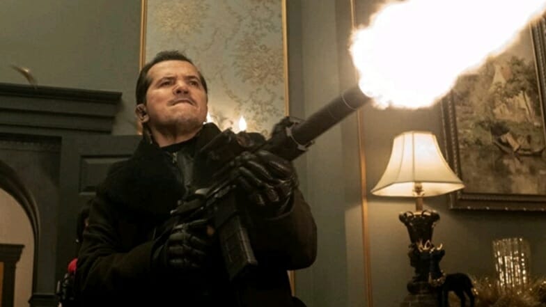 John Leguizamo stars the evil mercenary code named Scrooge blasting up a rich mansion with a machine gun in the Christmas action comedy VIOLENT NIGHT. 