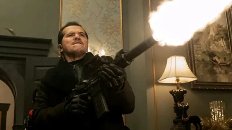 John Leguizamo stars the evil mercenary code named Scrooge blasting up a rich mansion with a machine gun in the Christmas action comedy VIOLENT NIGHT. 