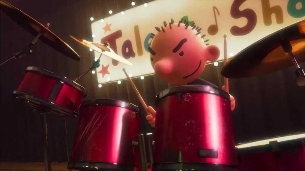 The mean-faced Rodrick Heffley bangs the drums at the school talent show from the new animated sequel film DIARY OF A WIMPY KID: RODRICK RULES now streaming on Disney+ in December 2022.