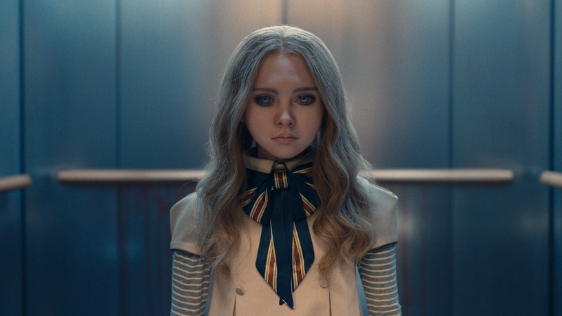 The life-sized M3GAN killer doll looks terrifyingly evil as she walks out of an elevator in the latest horror film from Blumhouse and Atomic Monster Productions.