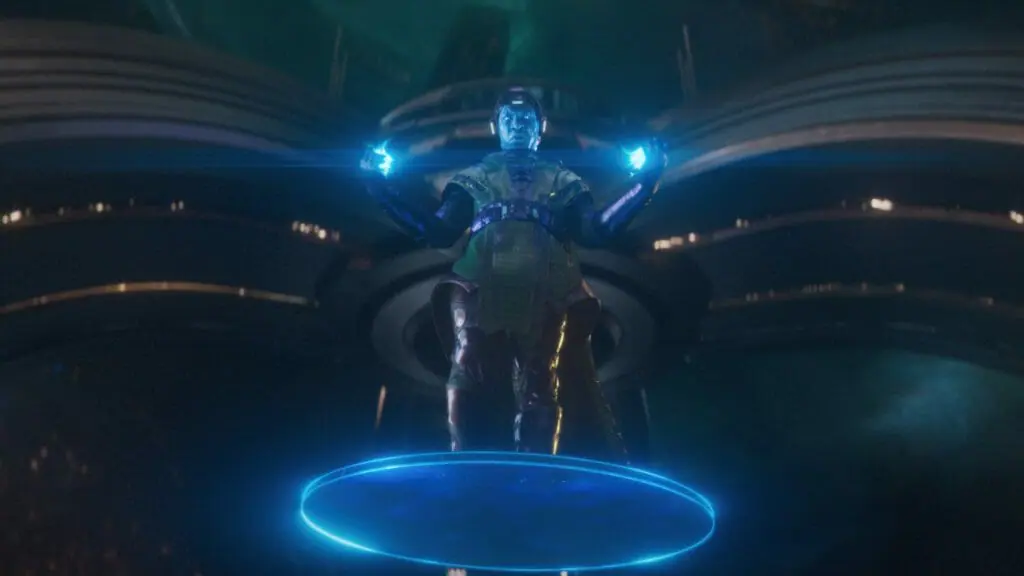 Jonathan Majors as Kang the Conqueror floats down on a blue energy disk in Ant-Man and the Wasp: Quantumania.