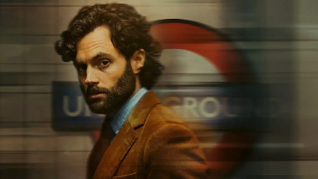 Penn Badgley stars as Joe Goldberg looking suspicious in an underground London subway station in YOU Season 4 coming to Netflix in February 2023.