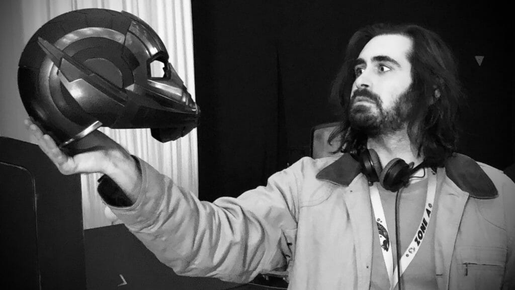 ANT-MAN AND THE WASP: QUANTUMANIA writer Jeff Loveness holds a prop of the actual Ant-Men helmet taken from behind the scenes of the Marvel film. 