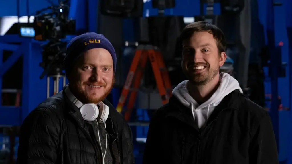 Directors Bryan Woods and Scott Beck smile together for a photo on the set and behind the scenes of their sci-fi dinosaur action movie 65.