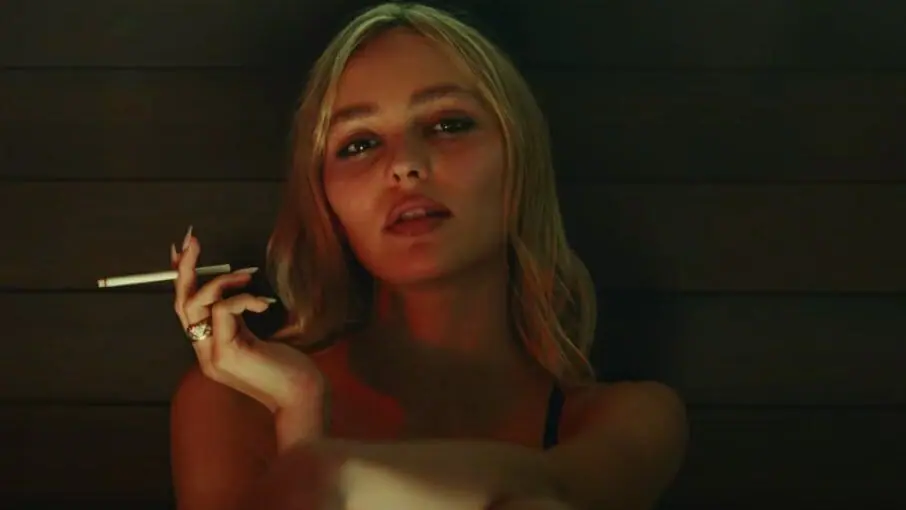 Lily-Rose Depp stars as the sexy pop star Jocelyn while smoking a cigarette in the HBO original series THE IDOL.
