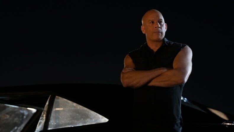 ‘Fast X’ Review – First Part of Finale Accelerates the Series Vin Diesel stars as Dominic Toretto wearing a black vest and posing with his arms crossed while leaning on his new black charger in FAST X.