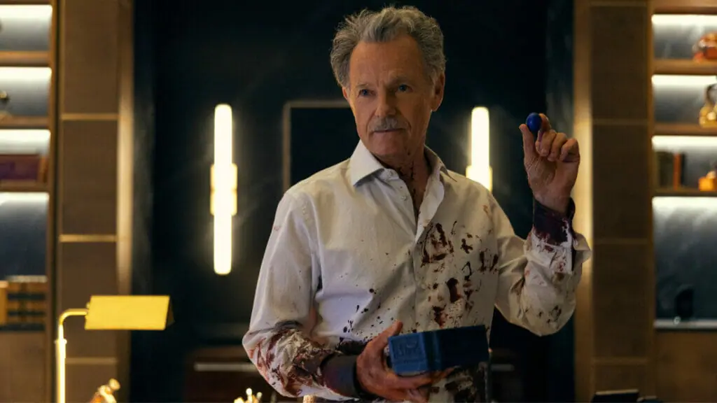 Bruce Greenwood stars as pharmaceutical CEO Roderick Usher wearing a shirt covered in blood in the Netflix original horror series THE FALL OF THE HOUSE OF USHER.