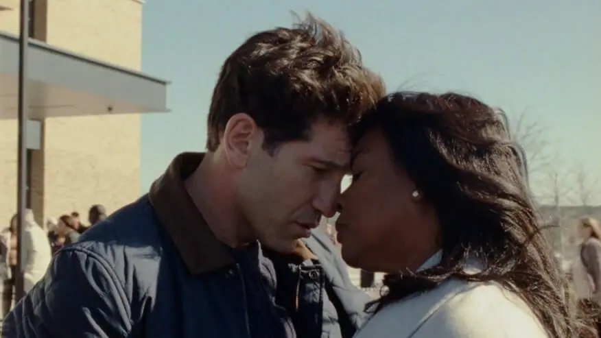 Aunjanue Ellis and Jon Bernthal embrace each other with a loving hug in the film ORIGIN written and directed by Ava DuVernay.