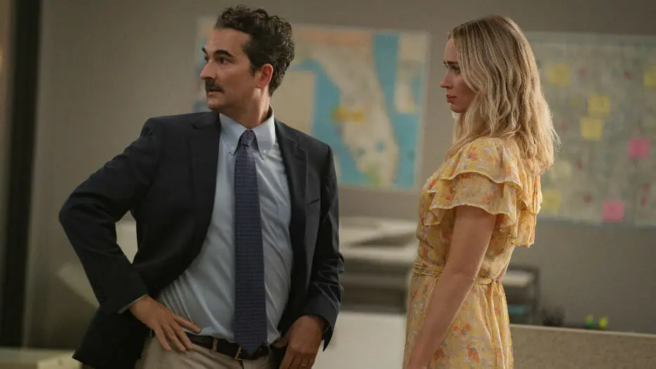 Jay Duplass and Emily Blunt star as two pharmaceutical sales reps in the Netflix original film PAIN HUSTLERS.