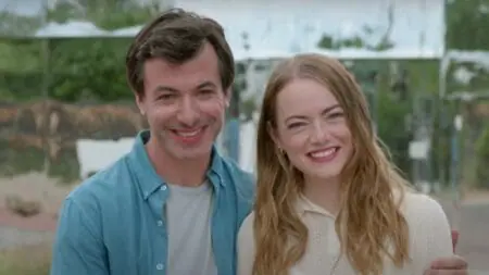 Nathan Fielder and Emma Stone try to pose happy together as a newly married couple with fake smiles in the A24 TV show THE CURSE.