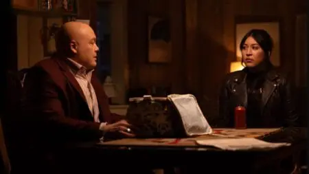 Vincent D'Onofrio as the Kingpin and Alaqua Cox as Maya Lopez sit together as he opens up a secret box on a table during a tense scene from Marvel's ECHO streaming on Disney+ and Hulu.