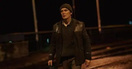 Cillian Murphy walks alone in the middle of an empty street in the small town of New Ross, Ireland at night during the wintertime in the period drama film SMALL THINGS LIKE THESE.