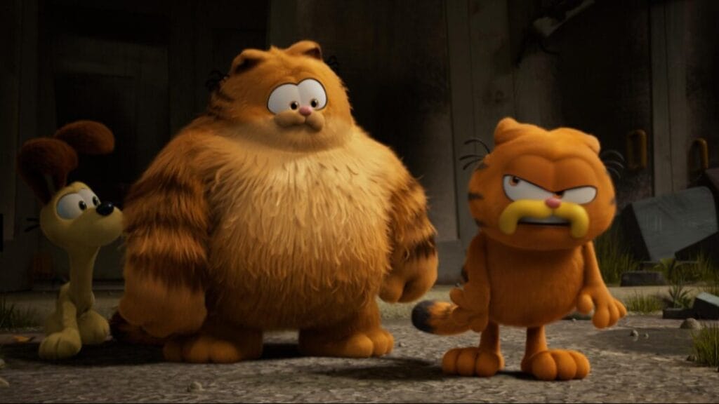 Garfield looking frustrated and upset walks away from his scruffy looking father Vic and best friend Odie the yellow beagle in THE GARFIELD MOVIE.