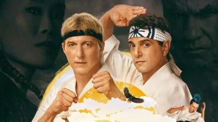 William Zabka as Johnny Lawrence and Ralph Macchio as Daniel LaRusso strike fighting poses in their white Karate uniforms on the official poster for COBRA KAI Season 6 Part 1 coming to Netflix in July 2024.