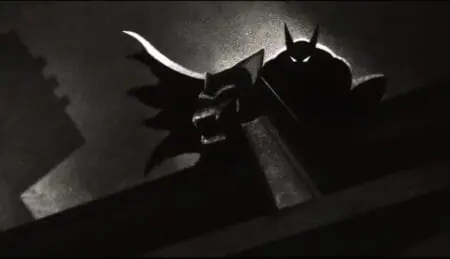 A black-and-white silhouette of Batman perched on top of a gargoyle in the 1940s themed animated series BATMAN: CAPED CRUSADER now streaming on Amazon Prime Video in August 2024.