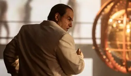 Colin Farrell strikes a pose as Oswald "Oz" Cobb looking over his shoulder in a fancy white suit in the HBO original spin-off series THE PENGUIN coming to the Max streaming service in September 2024.