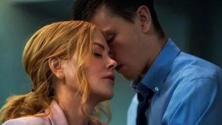 Nicole Kidman and Harris Dickinson share an intimate moment touching foreheads together in an office setting, which fuels their forbidden romance in the erotic thriller film BABYGIRL.