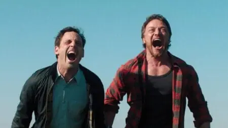 James McAvoy and Scoot McNairy stand side by side while screaming at the top of their lungs in the 2024 remake of the horror film SPEAK NO EVIL.