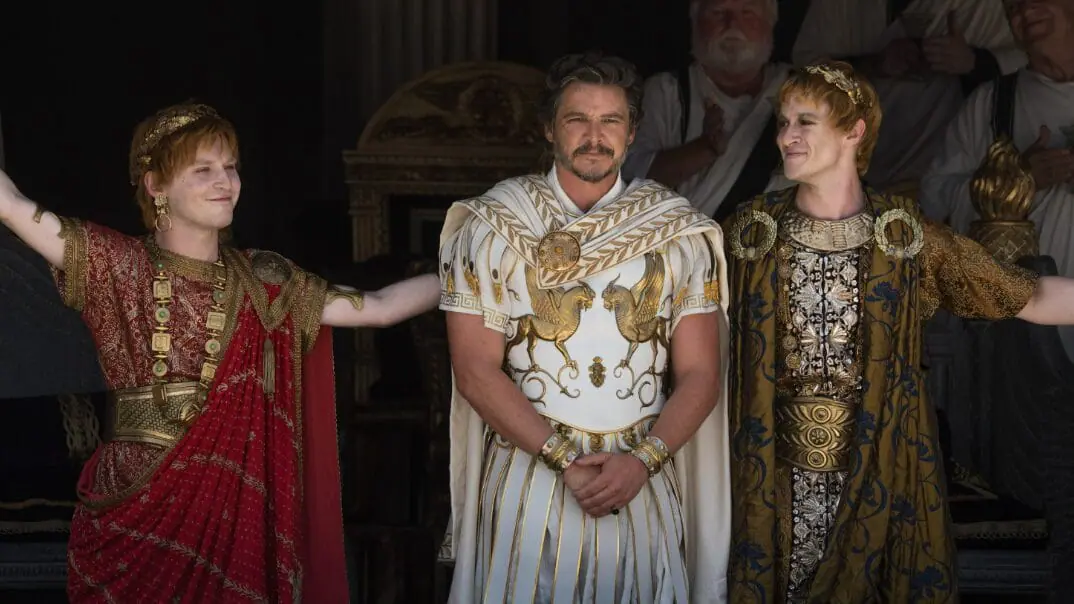 Fred Hechinger as Emperor Caracalla and Joseph Quinn as Emperor Geta congratulate and honor General Marcus Acacius, played by Pedro Pascal, in front of the Roman people in the legacy sequel GLADIATOR II. 