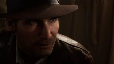 A close up of Indiana Jones, now voiced by Troy Baker, in his iconic brown fedora in the video game INDIANA JONES AND THE GREAT CIRCLE.