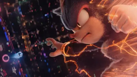 Shadow the Hedgehog charges his fist with orange electric energy as he flies down from the sky towards Sonic in the movie sequel SONIC THE HEDGEHOG 3.