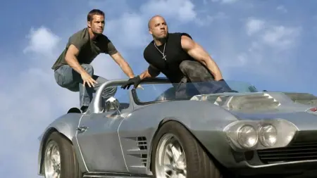 Paul Walker and Vin Diesel prepare to jump off a silver corvette in FAST 5, which is one of the multiple Fast & Furious movies leaving Netflix on February 12, 2025.