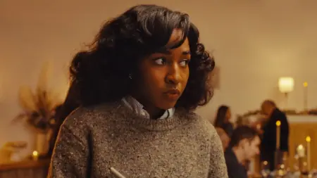 Ayo Edebiri stars as music journalist Ariel Ecton looking nervous as she writes down observations in her notepad in the new A24 horror movie OPUS.