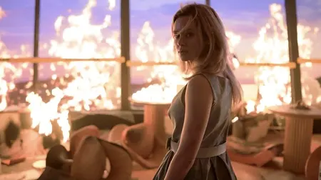 Brec Bassinger stands in the middle of a luxurious Sky View Tower restaurant on fire in during the opening set piece of FINAL DESTINATION: BLOODLINES.