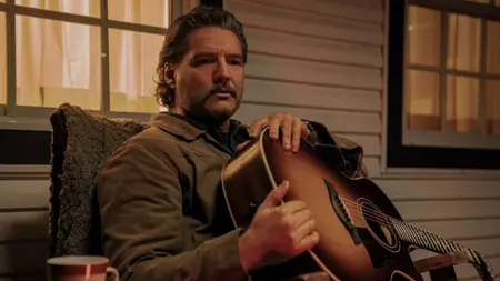 Episode 6 of ‘The Last of Us’ Season 2 Showcases the HBO Adaptation’s Worst Habits Pedro Pascal stars as Joel Miller looking somber as he holds an acoustic guitar during the iconic porch scene as depicted in The Last of Us Season 2 Episode 6 on HBO.