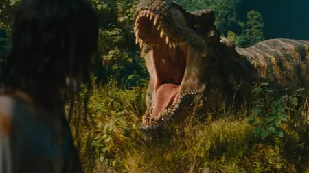 A new green and yellow striped T-Rex opens its mouth for a powerful roar in the sequel JURASSIC WORLD REBIRTH.